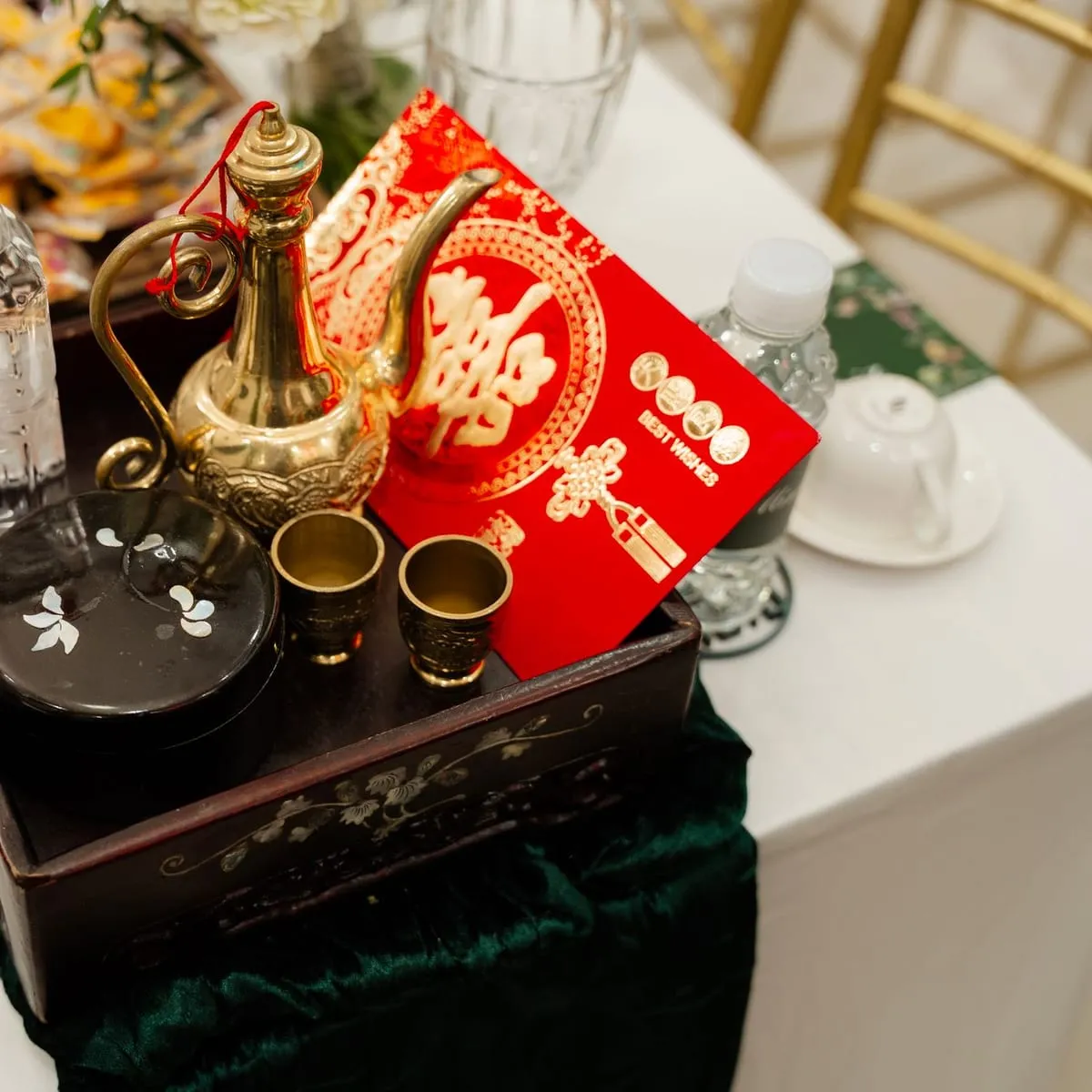 Juego de té servido junto a un sobre rojo de celebración